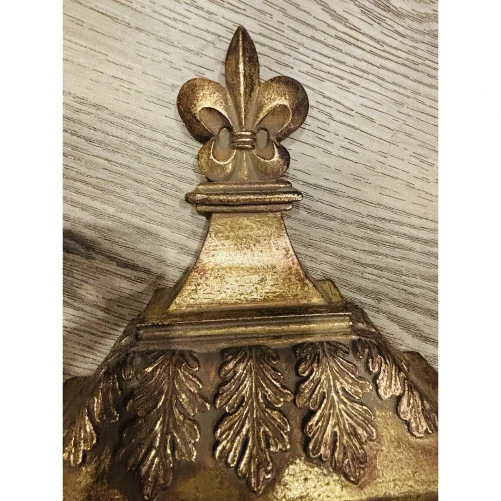 Vintage gold-toned decorative wall shelves with floral motifs.